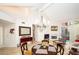 Open-concept living and dining area with vaulted ceiling, fireplace, and large windows at 4911 Mount Pleasant Ln, Las Vegas, NV 89113