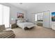 Spacious bedroom with ensuite bathroom, lounge chair, and large windows at 507 Serenity Point Dr, Henderson, NV 89012