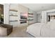 The primary suite is light and bright, with a fireplace, shelving and oversized windows with privacy drapes at 507 Serenity Point Dr, Henderson, NV 89012
