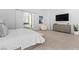 Well-lit bedroom with a view to the bathroom, lounge seating, and modern decor at 507 Serenity Point Dr, Henderson, NV 89012