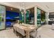 Open dining room with a modern table setting and seamless access to an outdoor patio with scenic views at 507 Serenity Point Dr, Henderson, NV 89012