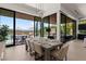 Elegant dining room with large sliding glass doors leading to an outdoor dining space with scenic views at 507 Serenity Point Dr, Henderson, NV 89012