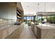 Sleek kitchen with stainless steel appliances and sliding glass doors to outdoor dining and pool at 507 Serenity Point Dr, Henderson, NV 89012