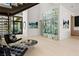 Stylish living area with a glass-enclosed wine display, modern art, and an open layout, perfect for entertaining guests at 507 Serenity Point Dr, Henderson, NV 89012