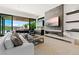 Elegant living room featuring a cozy fireplace, modern decor, and sliding glass doors that seamlessly blend indoor/outdoor living at 507 Serenity Point Dr, Henderson, NV 89012