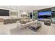 Open-concept living area with sleek furnishings, a modern kitchen, and access to outdoor entertainment at 507 Serenity Point Dr, Henderson, NV 89012