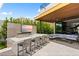 Outdoor kitchen and dining area with built in grill and bar, perfect for enjoying meals and entertaining guests at 507 Serenity Point Dr, Henderson, NV 89012