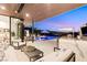 Enjoy an outdoor bar and lounge area by the pool with breathtaking city views at twilight at 507 Serenity Point Dr, Henderson, NV 89012