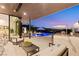 Inviting patio with lounge seating, outdoor dining area, and a view of the sparkling pool at 507 Serenity Point Dr, Henderson, NV 89012