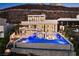 Spectacular backyard pool with a built-in fire pit, lounge area, and modern design elements perfect for outdoor entertaining at 507 Serenity Point Dr, Henderson, NV 89012