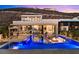 A stunning backyard with an infinity pool, outdoor kitchen and living area, and views of the surrounding landscape at 507 Serenity Point Dr, Henderson, NV 89012