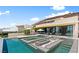 Luxury home with an expansive pool, integrated spa, outdoor kitchen, and lounge area perfect for entertaining at 507 Serenity Point Dr, Henderson, NV 89012
