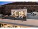 Stunning rooftop patio with modern furniture, fire pit, and ping pong table overlooking scenic mountain views at 507 Serenity Point Dr, Henderson, NV 89012
