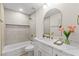 Bright bathroom with white marble countertops, white cabinets, tiled walls, and a modern shower head at 5157 Future Dr, Las Vegas, NV 89130