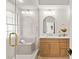 Bright bathroom with a glass enclosed shower, tiled bench, white walls and a wooden vanity with white marble countertops at 5157 Future Dr, Las Vegas, NV 89130