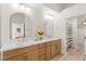 Bathroom with double vanity, modern fixtures, wood cabinets, stone countertop, and walk-in closet at 5157 Future Dr, Las Vegas, NV 89130