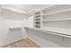 Walk-in closet with wood flooring, white walls, and custom built in shelving at 5157 Future Dr, Las Vegas, NV 89130