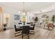 Open concept dining area with updated chandelier and luxury furniture seamlessly connects to a cozy living space at 5157 Future Dr, Las Vegas, NV 89130