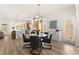 Open concept dining area with updated chandelier and luxury kitchen in a seamless, modern design at 5157 Future Dr, Las Vegas, NV 89130