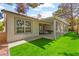 Back exterior of a house showing the covered patio and artificial turf at 5157 Future Dr, Las Vegas, NV 89130