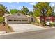 Charming home with a two-car garage, well-manicured lawn, and mature trees at 5157 Future Dr, Las Vegas, NV 89130