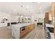 Spacious kitchen featuring a large island, stainless steel appliances, and a seamless design flowing into the living area at 5157 Future Dr, Las Vegas, NV 89130