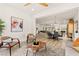 Spacious living room showcases open layout, wooden floors and seamlessly connects to a dining space and kitchen at 5157 Future Dr, Las Vegas, NV 89130