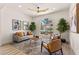 Inviting living room with a stylish ceiling fan, neutral tones, modern furnishings and a large arched window at 5157 Future Dr, Las Vegas, NV 89130