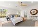 Bedroom featuring a stylish ceiling fan, serene decor, and an ensuite bathroom, creating a private oasis at 5157 Future Dr, Las Vegas, NV 89130