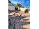 Backyard with red flagstone, tiered walls, and a built-in firepit at 5243 Sunnywood Dr, Las Vegas, NV 89120