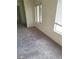 A bright bedroom space with carpet, windows, and ensuite bathroom at 5243 Sunnywood Dr, Las Vegas, NV 89120