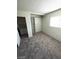 Carpeted bedroom featuring built-in closet shelving and a window at 5243 Sunnywood Dr, Las Vegas, NV 89120