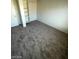 Neutral colored carpeted bedroom includes a closet and built-in shelving at 5243 Sunnywood Dr, Las Vegas, NV 89120