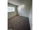 Clean, carpeted bedroom features neutral walls and a window at 5243 Sunnywood Dr, Las Vegas, NV 89120