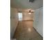 Hallway featuring tiled floors, ceiling fan, and multiple rooms leading to a spacious floor plan at 5243 Sunnywood Dr, Las Vegas, NV 89120