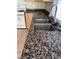 Kitchen with stainless steel sink, granite countertops, and tile flooring at 5243 Sunnywood Dr, Las Vegas, NV 89120