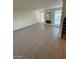 Open-concept living room with tiled floors, large windows, and a decorative fireplace at 5243 Sunnywood Dr, Las Vegas, NV 89120