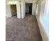 Bright living room featuring carpet, a large window, and access to a bathroom at 5243 Sunnywood Dr, Las Vegas, NV 89120