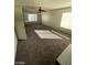 An expansive living room area with carpet, ample natural light, and a ceiling fan at 5243 Sunnywood Dr, Las Vegas, NV 89120