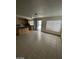 Living room and kitchen area with lots of natural light and sliding glass doors to patio at 5243 Sunnywood Dr, Las Vegas, NV 89120
