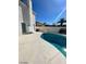 A kidney-shaped pool with a diving board and white concrete surround is great for outdoor enjoyment at 5243 Sunnywood Dr, Las Vegas, NV 89120