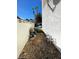 Narrow side yard showing equipment near the wall and the rear pool area at 5243 Sunnywood Dr, Las Vegas, NV 89120