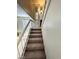 Carpeted staircase with white railing and natural light at 5243 Sunnywood Dr, Las Vegas, NV 89120