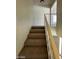 Carpeted staircase with white railing leading to the second floor at 5243 Sunnywood Dr, Las Vegas, NV 89120