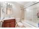 Cozy bathroom with a vanity, toilet, and a shower-tub combination with glass doors at 5505 Reiter Ave, Las Vegas, NV 89108