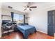 Bedroom featuring wood floors, ceiling fan, built-in shelves and a window with neighborhood views at 5505 Reiter Ave, Las Vegas, NV 89108