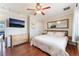 Comfortable bedroom with wood floors, a TV, and ample closet space for storage at 5505 Reiter Ave, Las Vegas, NV 89108