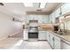 Kitchen with white cabinets, stainless steel appliances, and a double sink with a modern faucet at 5505 Reiter Ave, Las Vegas, NV 89108