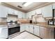 Bright kitchen featuring stainless appliances, tile flooring, and granite counters at 5505 Reiter Ave, Las Vegas, NV 89108