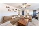 Living room featuring a cozy sectional sofa, ceiling fan, and Peloton exercise bike at 5505 Reiter Ave, Las Vegas, NV 89108